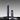 A luxury fountain pen and its cap displayed on a dark reflective surface against a gradient gray background. The pen features a deep purple marbled resin body with gold-plated accents on the tip, clip, and base.